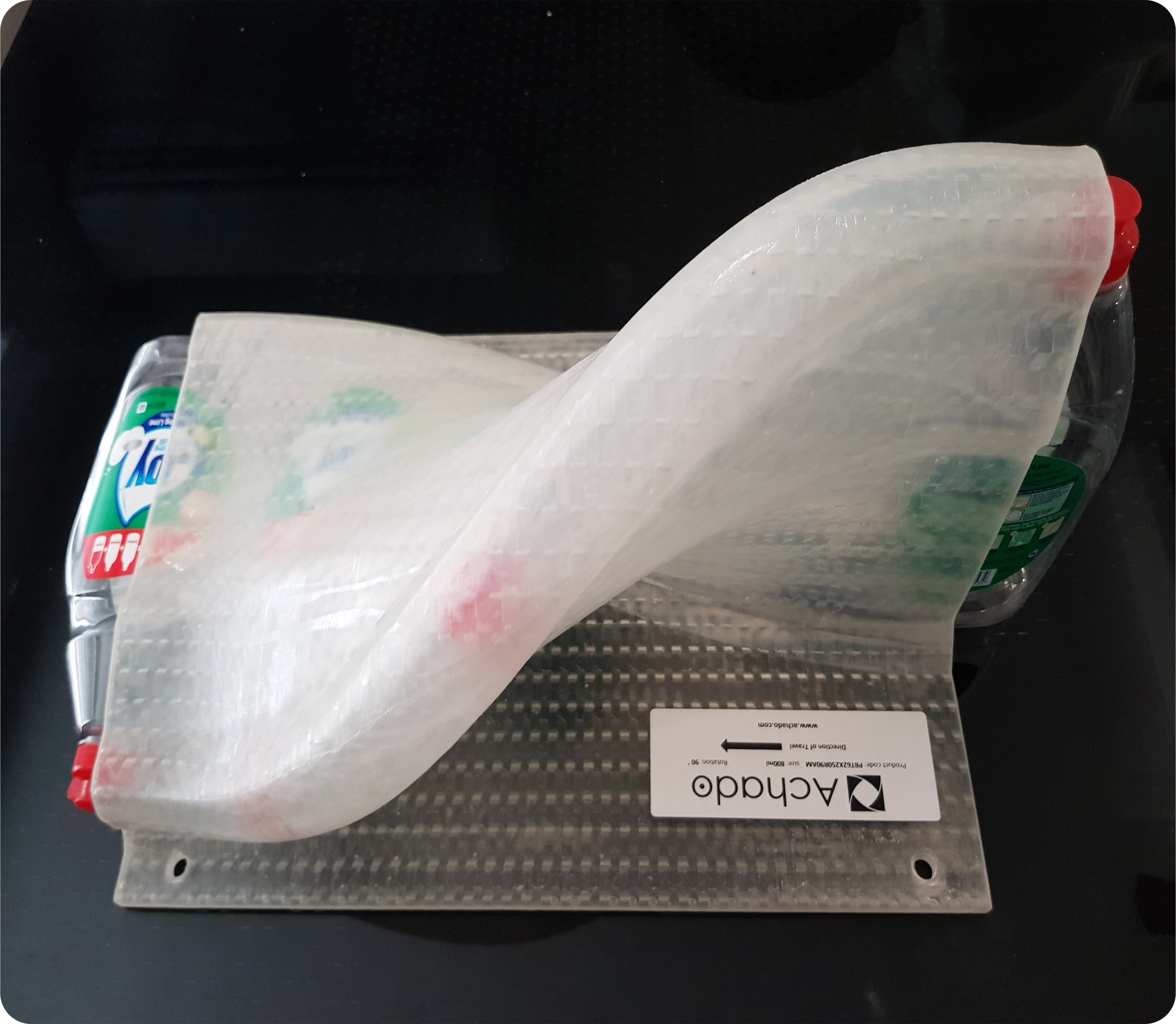 Plastic bottles being tilted 90 degrees