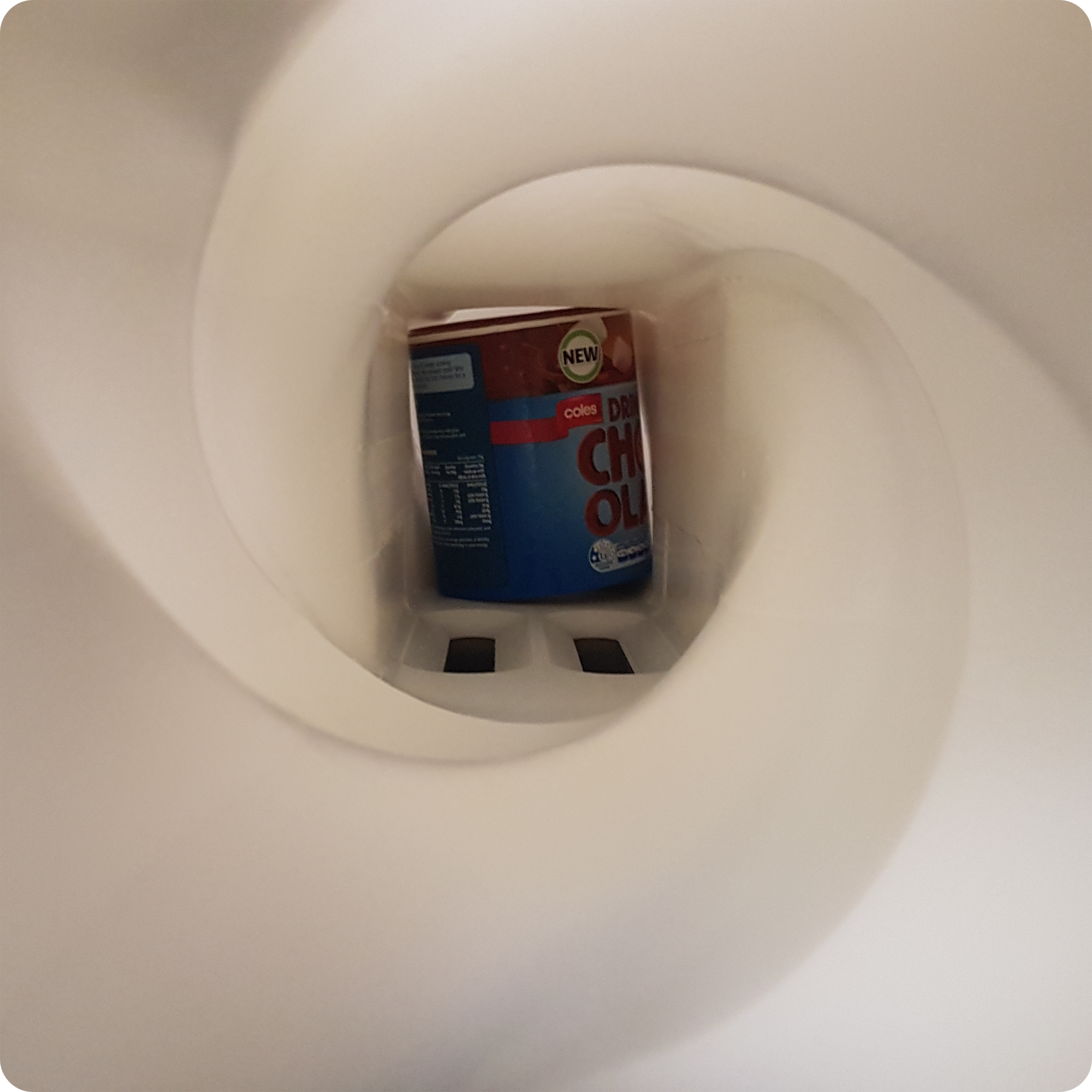 Food tin being turned upside down to be rinsed and then turned once more to be upright once again